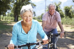 photo of older couple riding bicycles