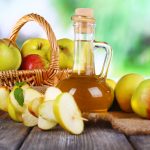 photo of apples and apple cider vinegar in a bottle