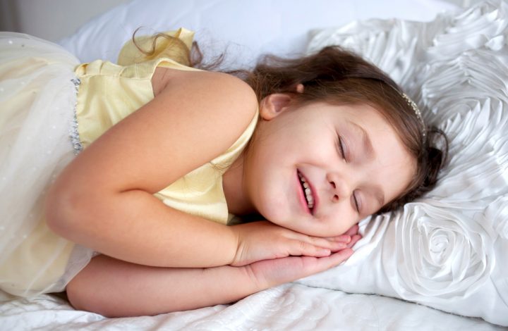 photo of smiling child in bed